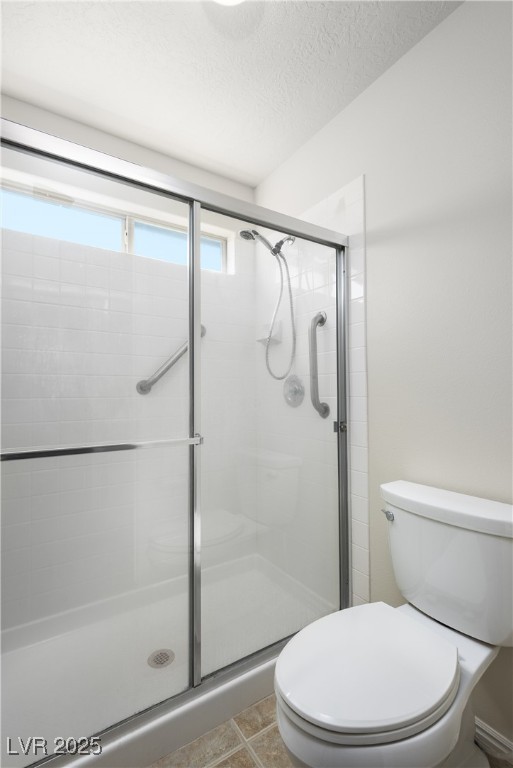 490 Ruby Drive Mesquite, NV 89027 - Photo 14 of 23 Bathroom featuring a shower stall, a textured ceiling, and tile patterned flooring