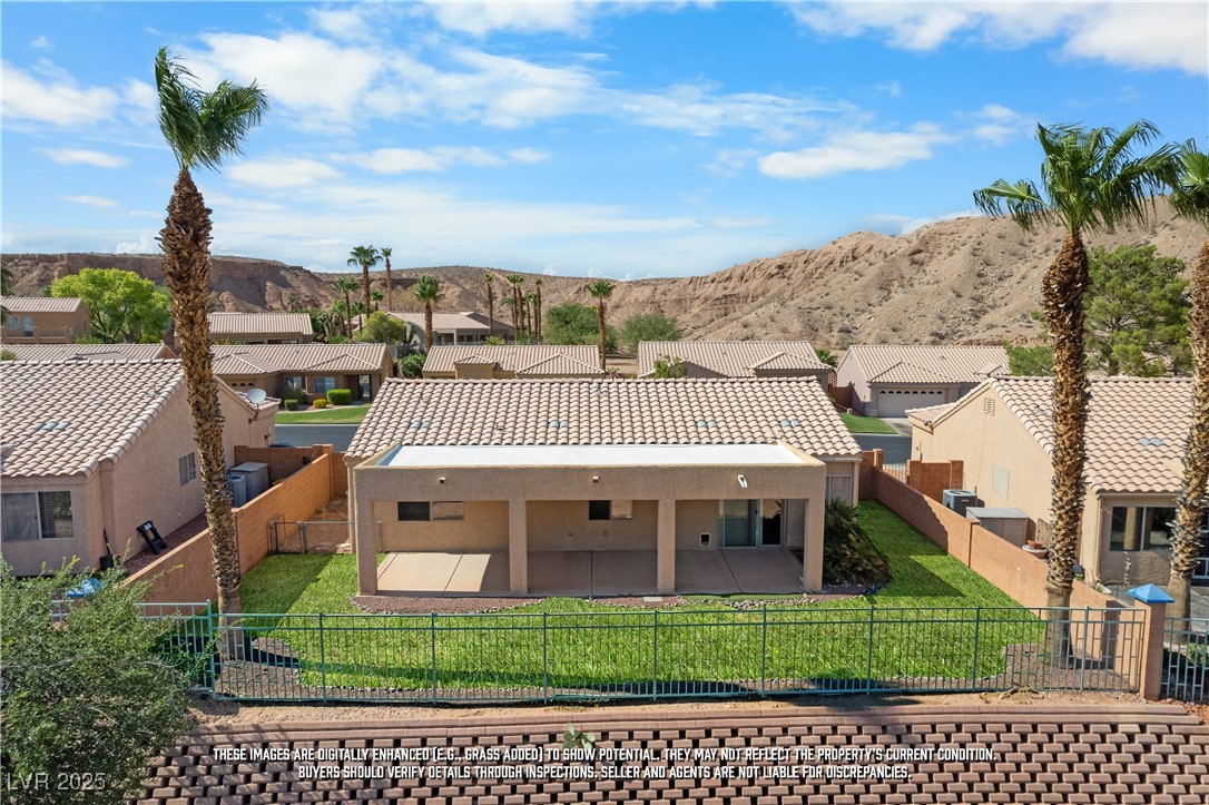 490 Ruby Drive Mesquite, NV 89027 - Photo 22 of 23 Rear view of property featuring a residential view, stucco siding, a tile roof, and a fenced backyard
