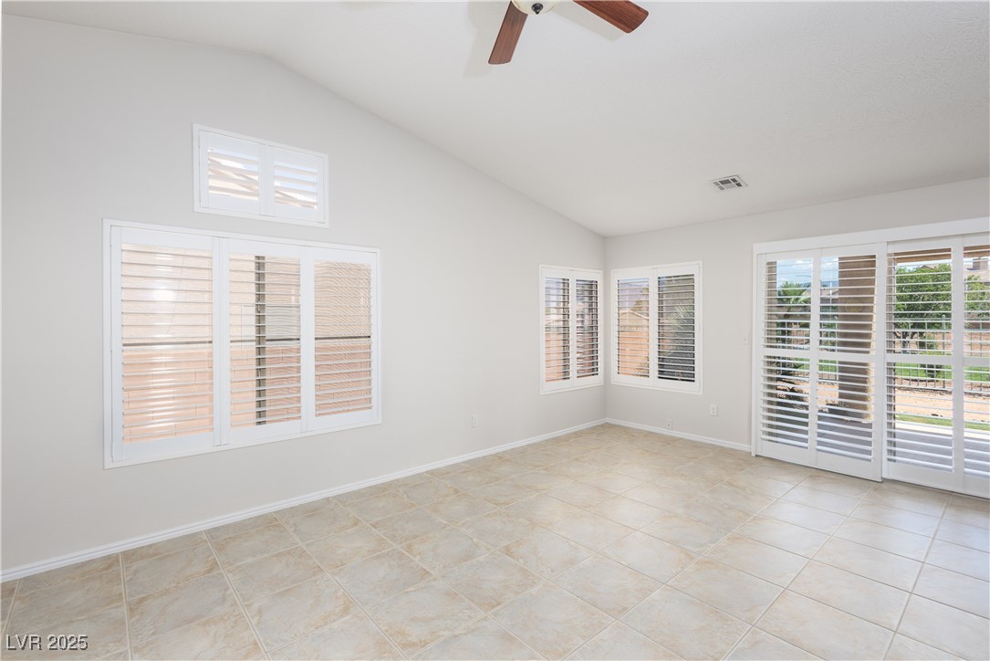 490 Ruby Drive Mesquite, NV 89027 - Photo 3 of 23 Unfurnished room featuring vaulted ceiling, a ceiling fan, and light tile patterned floors