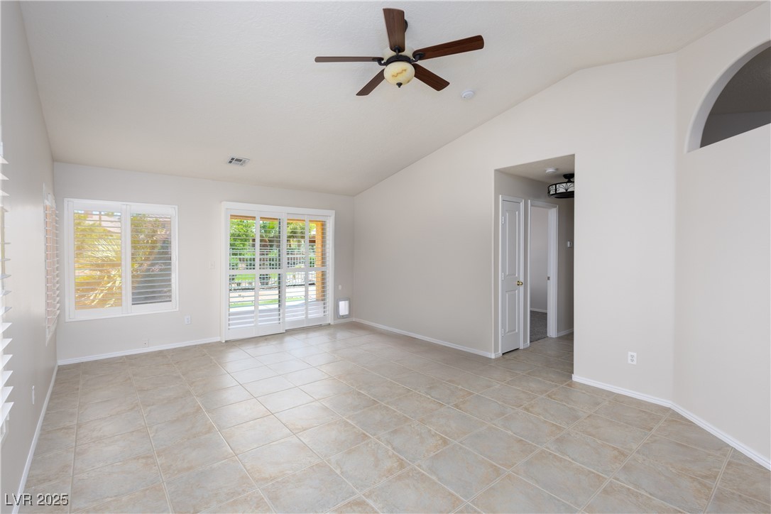 490 Ruby Drive Mesquite, NV 89027 - Photo 5 of 23 Unfurnished room featuring lofted ceiling, ceiling fan, and light tile patterned floors