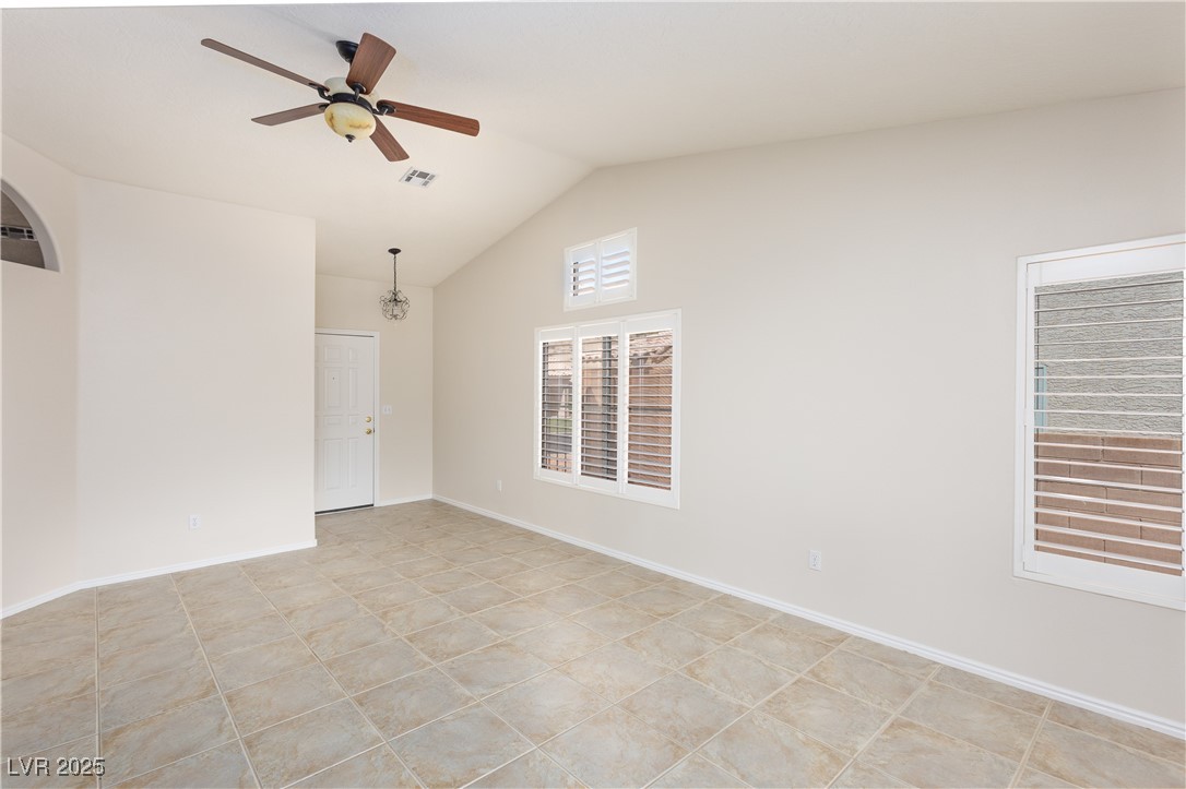 490 Ruby Drive Mesquite, NV 89027 - Photo 7 of 23 Empty room with vaulted ceiling, ceiling fan, and light tile patterned floors