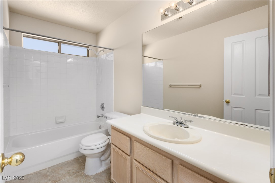 490 Ruby Drive Mesquite, NV 89027 - Photo 9 of 23 Full bath featuring bathtub / shower combination, vanity, light tile patterned flooring, and a textured ceiling