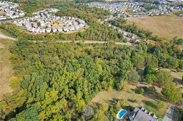 an aerial view of a residential houses with yard