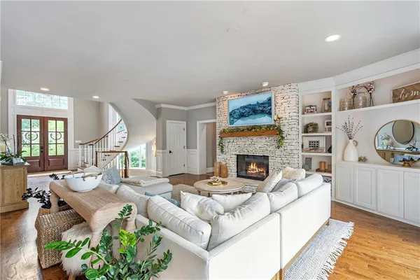 a living room with furniture a flat screen tv and a fireplace