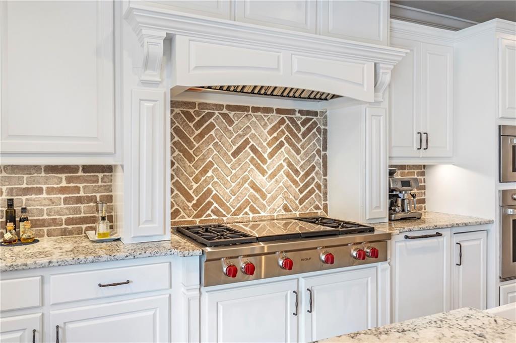 6026 GC Crow Road Flowery Branch, GA 30542 - Photo 18 of 100 a kitchen with granite countertop a sink and a stove