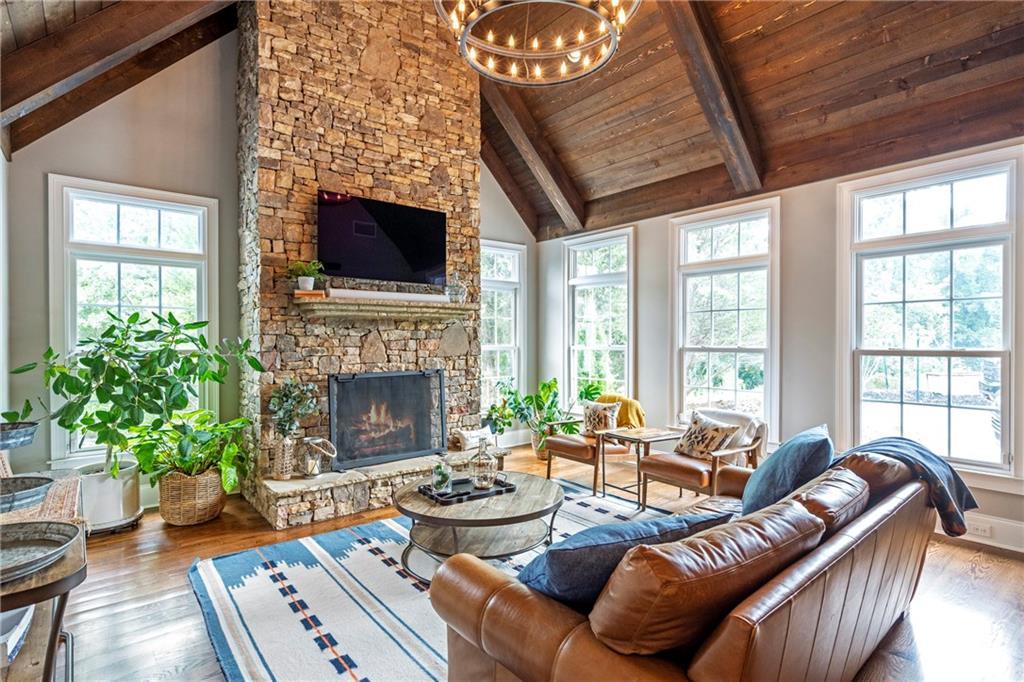 6026 GC Crow Road Flowery Branch, GA 30542 - Photo 24 of 100 a living room with furniture a flat screen tv and a fireplace