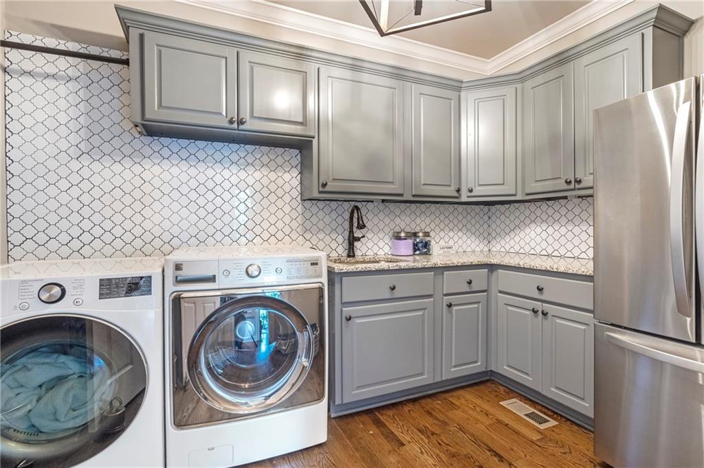 6026 GC Crow Road Flowery Branch, GA 30542 - Photo 27 of 100 a utility room with sink dryer and washer