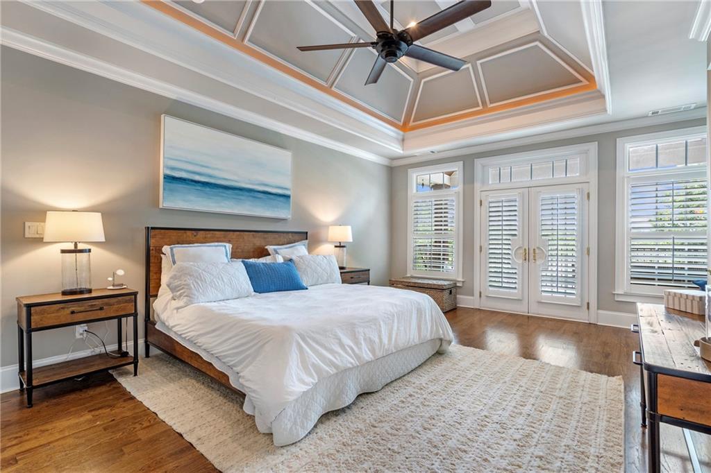 6026 GC Crow Road Flowery Branch, GA 30542 - Photo 28 of 100 a bedroom with a large bed and a chandelier