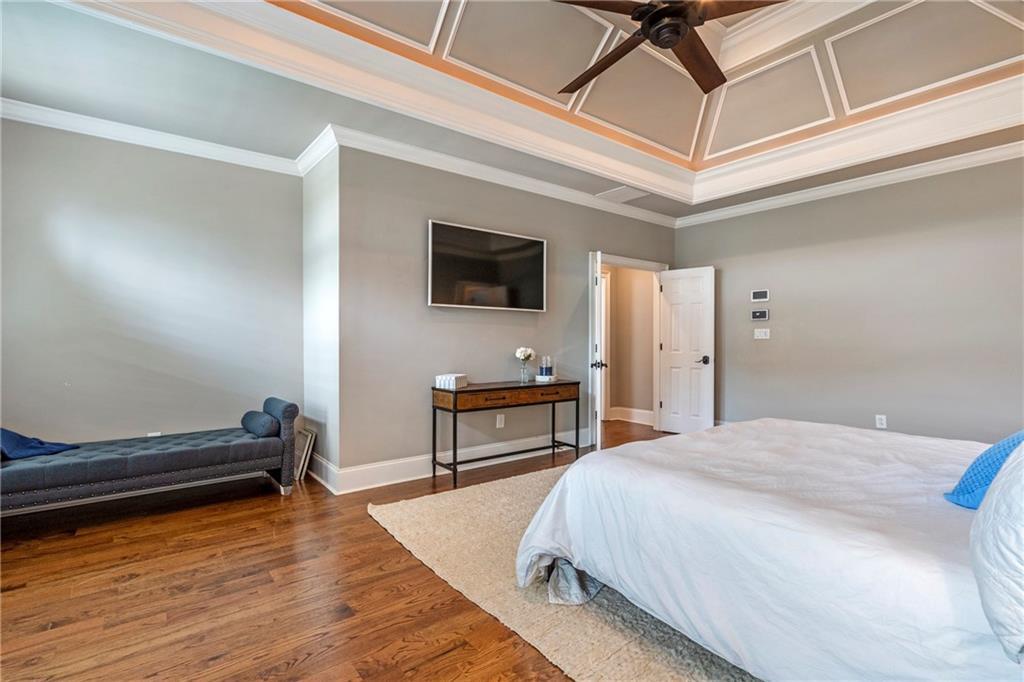 6026 GC Crow Road Flowery Branch, GA 30542 - Photo 30 of 100 a bedroom with a bed and a flat screen tv