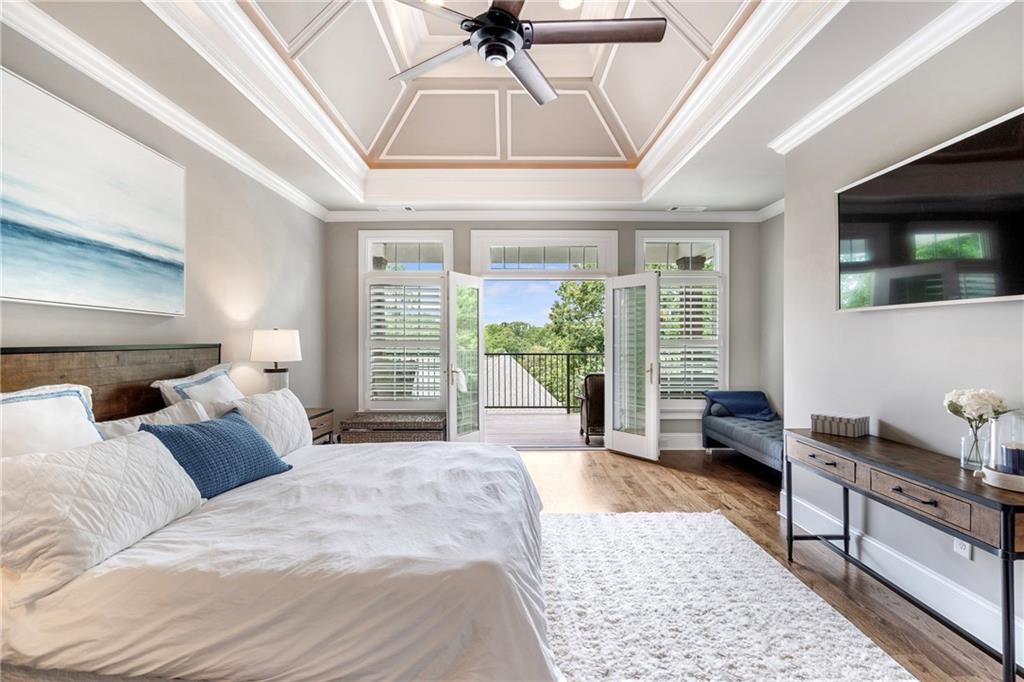 6026 GC Crow Road Flowery Branch, GA 30542 - Photo 31 of 100 a bedroom with a large bed and a flat tv screen on dresser