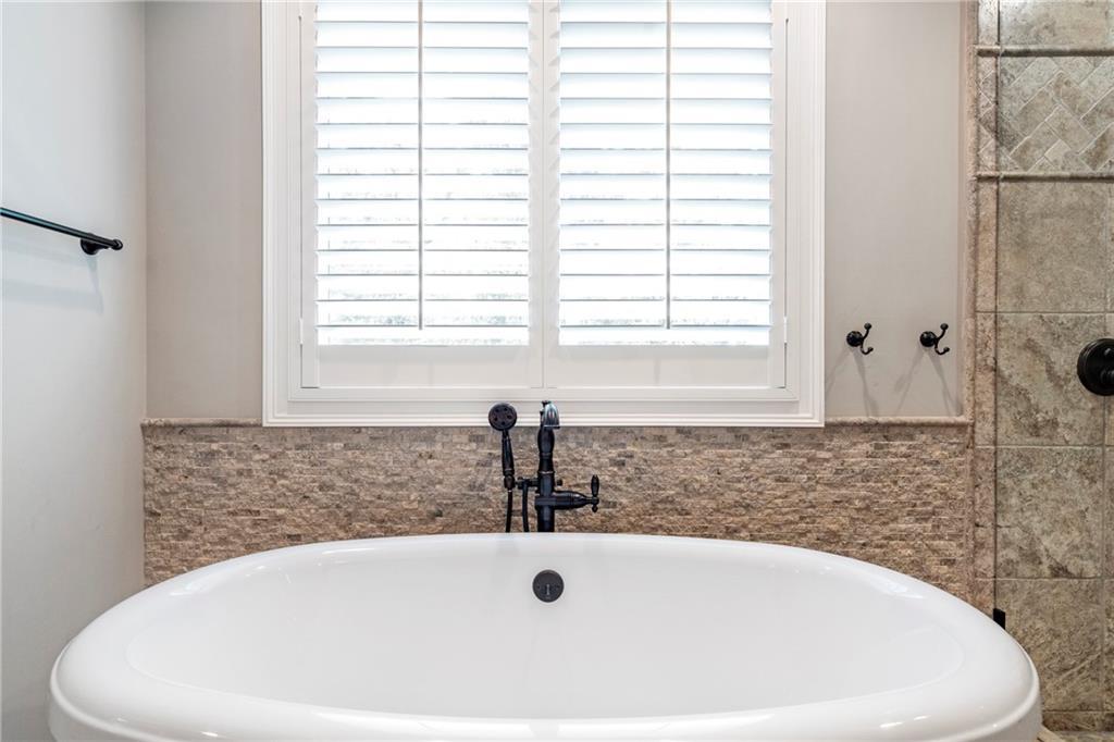 6026 GC Crow Road Flowery Branch, GA 30542 - Photo 35 of 100 a white bath tub sitting in a bathroom
