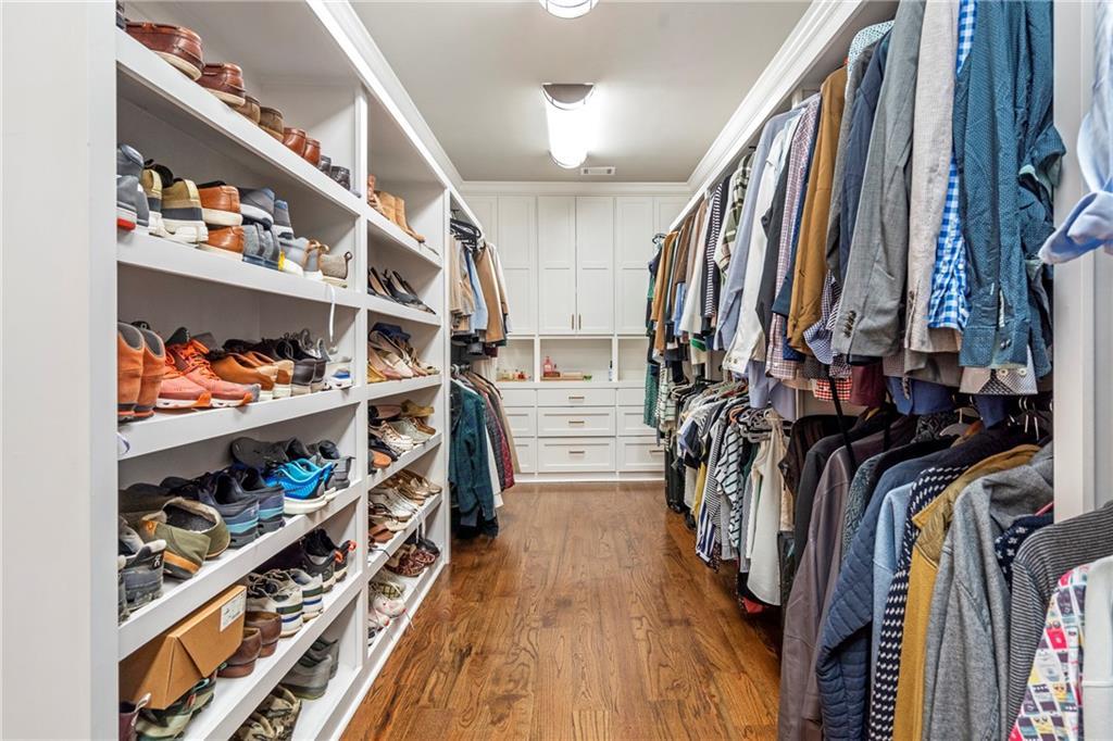 6026 GC Crow Road Flowery Branch, GA 30542 - Photo 36 of 100 a view of walk in closet with clothes and shoes