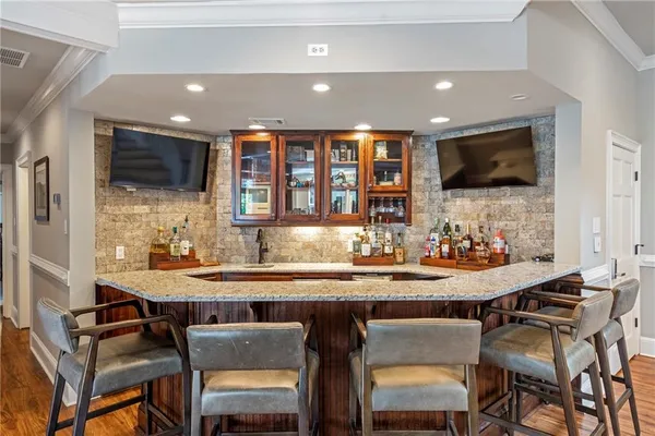 a bathroom with a granite countertop sink double and mirror