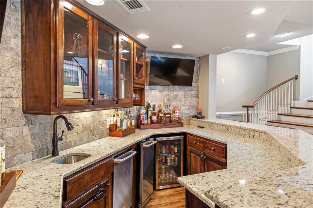 6026 GC Crow Road Flowery Branch, GA 30542 - Photo 39 of 100 a kitchen with stainless steel appliances granite countertop a sink a stove and a microwave