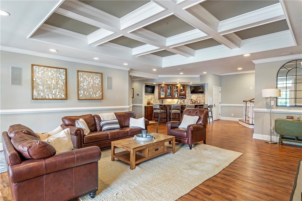 6026 GC Crow Road Flowery Branch, GA 30542 - Photo 41 of 100 a living room with furniture wooden floor and kitchen view