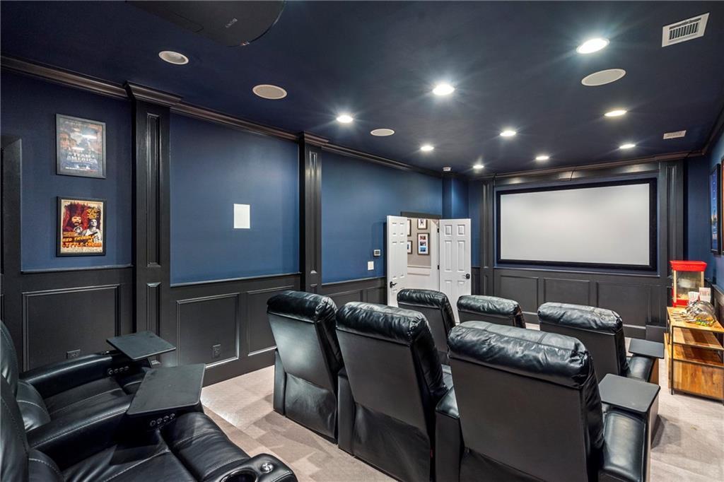 6026 GC Crow Road Flowery Branch, GA 30542 - Photo 44 of 100 a projector room with pool table a projector with a projector screen and couches