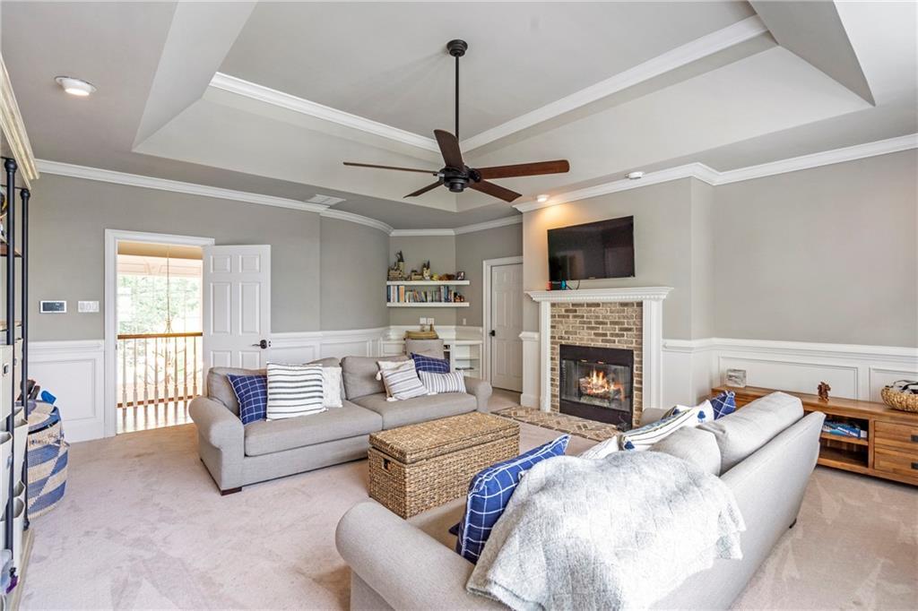 6026 GC Crow Road Flowery Branch, GA 30542 - Photo 61 of 100 a living room with furniture a fireplace and a flat screen tv