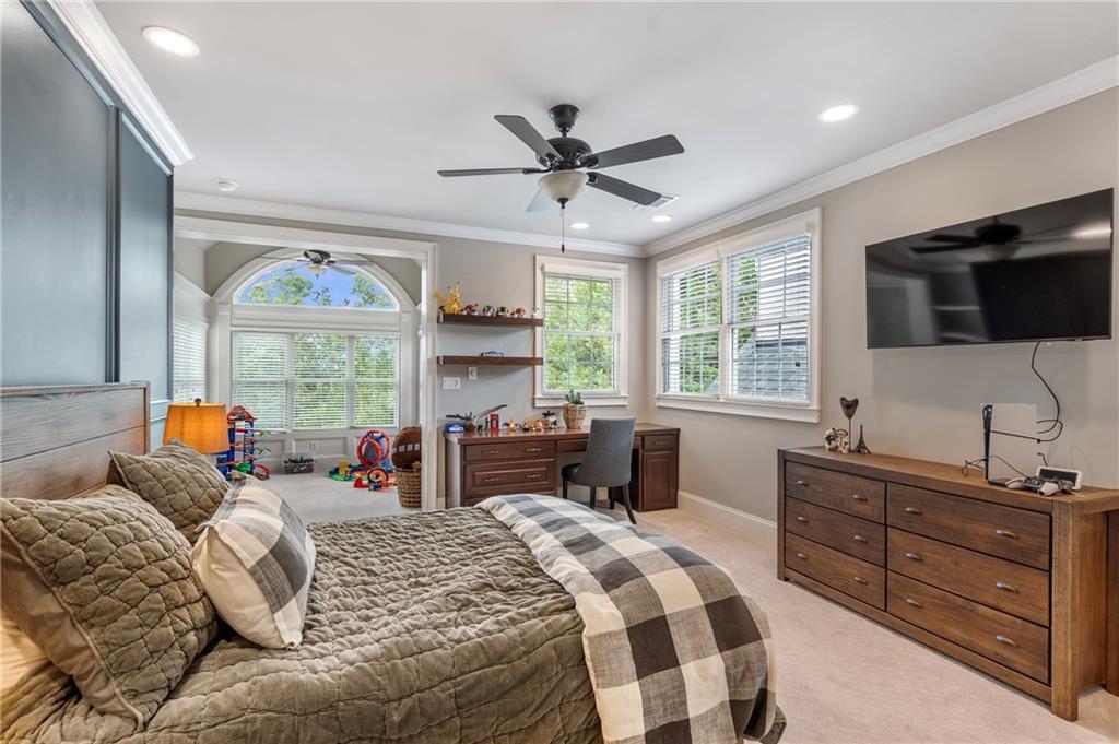 6026 GC Crow Road Flowery Branch, GA 30542 - Photo 64 of 100 a bedroom with a large bed and a flat tv screen on dresser