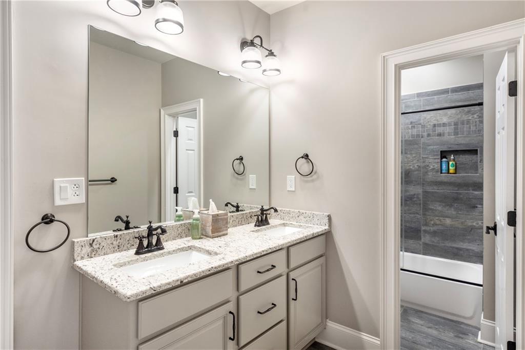 6026 GC Crow Road Flowery Branch, GA 30542 - Photo 66 of 100 a bathroom with a sink vanity granite and a mirror