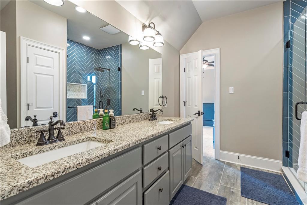 6026 GC Crow Road Flowery Branch, GA 30542 - Photo 70 of 100 a bathroom with a granite countertop sink double and mirror
