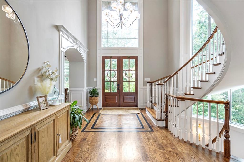 6026 GC Crow Road Flowery Branch, GA 30542 - Photo 8 of 100 a view of an entryway with wooden floor and windows