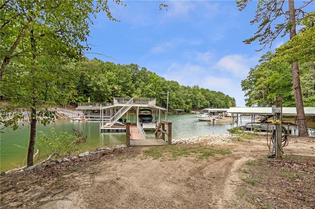 6026 GC Crow Road Flowery Branch, GA 30542 - Photo 85 of 100 a view of a lake with a bench and trees around