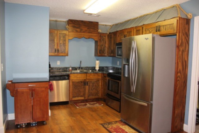 2965 Rumble Road Juliette, GA 31046 - Photo 5 of 8 a kitchen with stainless steel appliances granite countertop a refrigerator and a stove