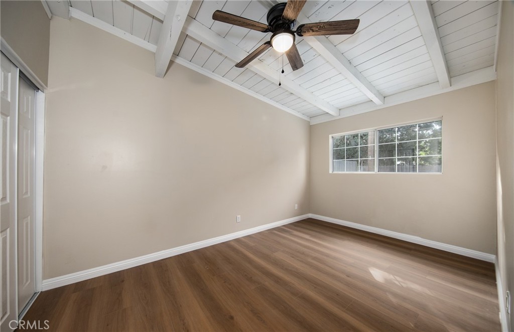 16924 Millstone Drive La Puente, CA 91744 - Photo 13 of 19 an empty room with wooden floor ceiling fan and windows
