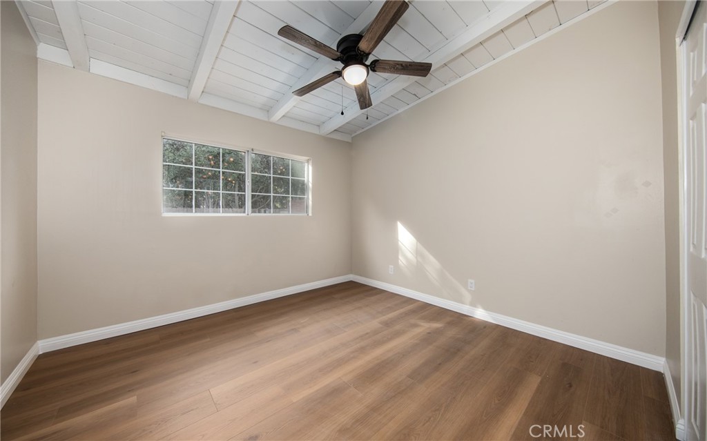 16924 Millstone Drive La Puente, CA 91744 - Photo 16 of 19 an empty room with wooden floor ceiling fan and windows