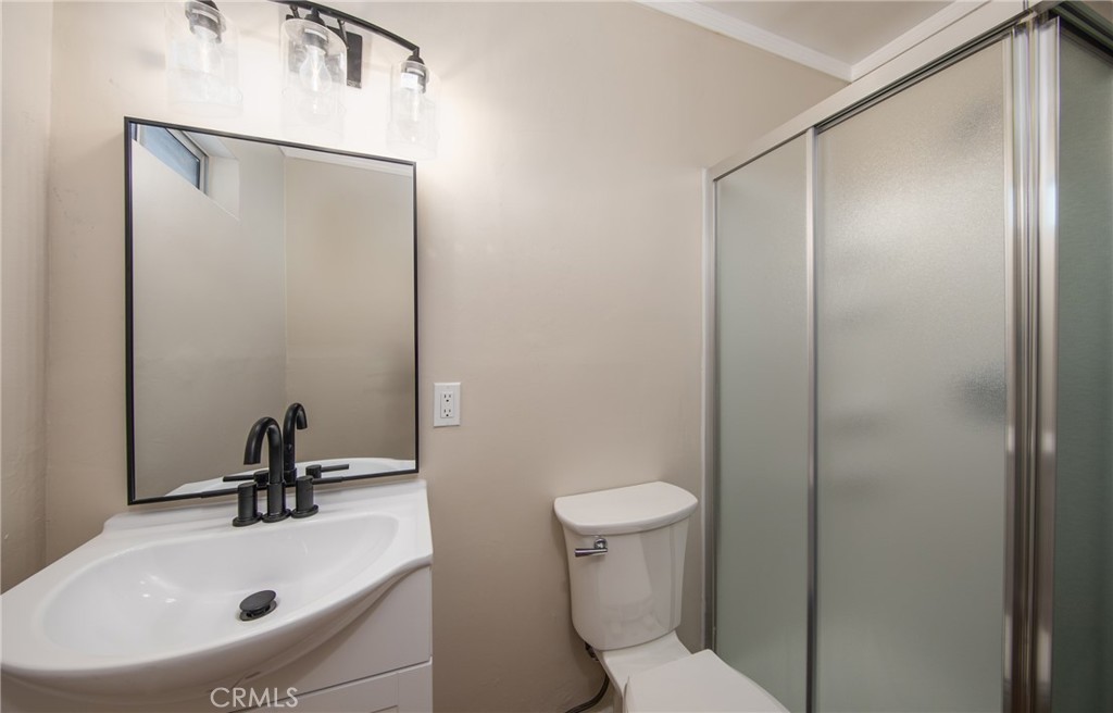 16924 Millstone Drive La Puente, CA 91744 - Photo 17 of 19 a bathroom with a sink a toilet and a mirror
