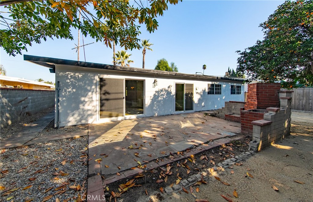 16924 Millstone Drive La Puente, CA 91744 - Photo 18 of 19 a view of a patio with a table chairs potted plants and a palm tree