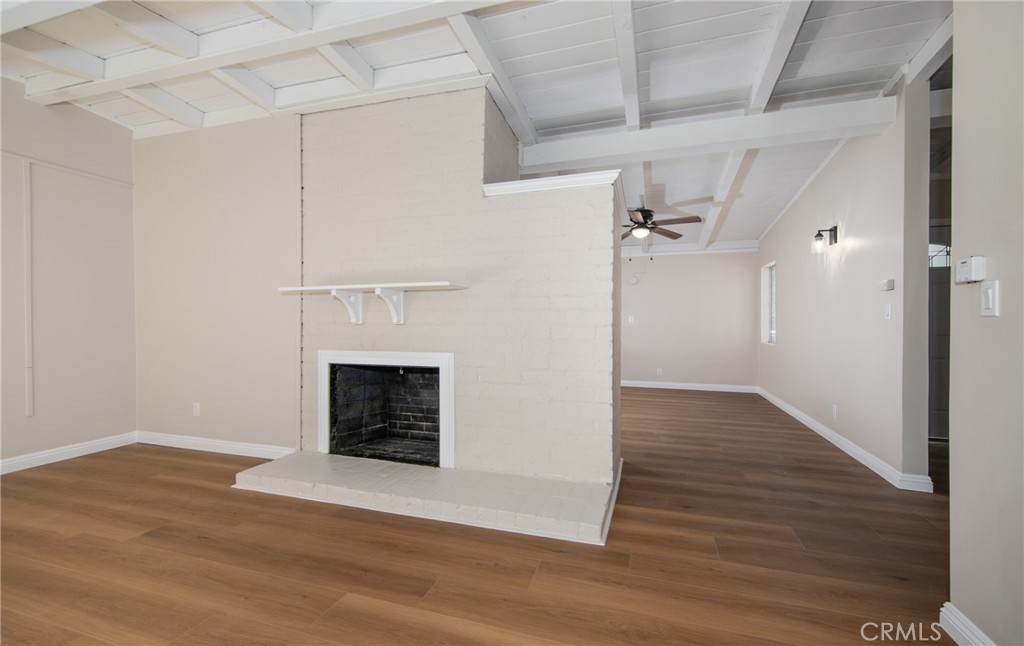 16924 Millstone Drive La Puente, CA 91744 - Photo 6 of 19 a view of an empty room with wooden floor fireplace and a window