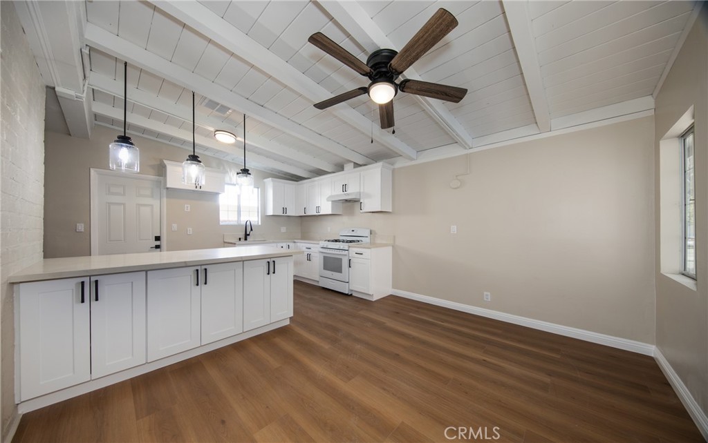 16924 Millstone Drive La Puente, CA 91744 - Photo 7 of 19 a kitchen with cabinets wooden floor and a ceiling fan