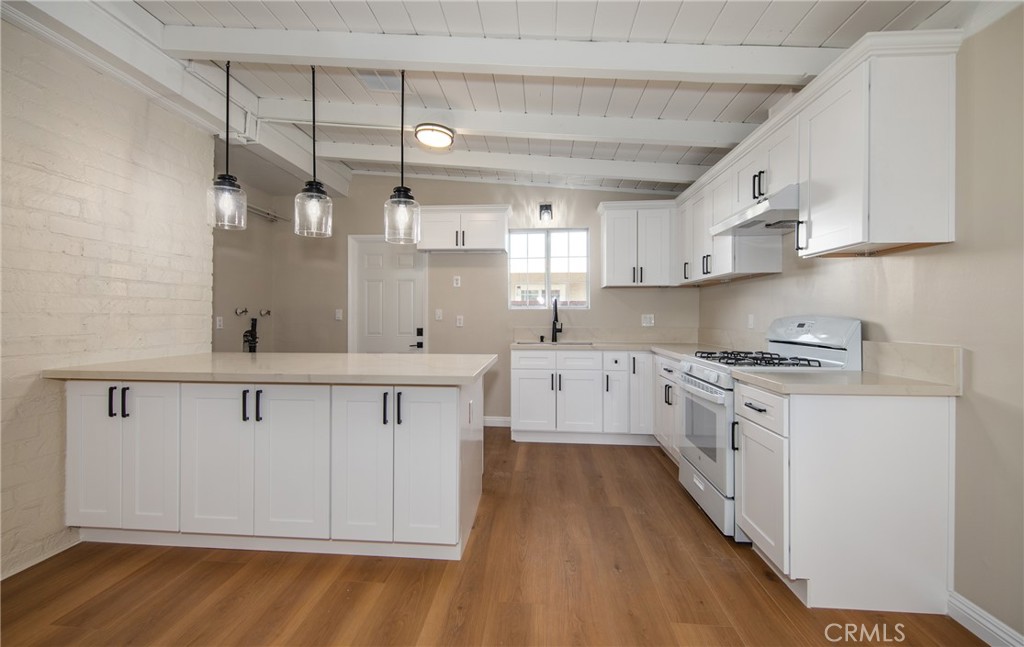 16924 Millstone Drive La Puente, CA 91744 - Photo 8 of 19 a kitchen with white cabinets sink and stove