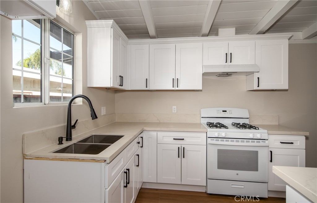 16924 Millstone Drive La Puente, CA 91744 - Photo 10 of 19 a kitchen with white cabinets appliances and a sink