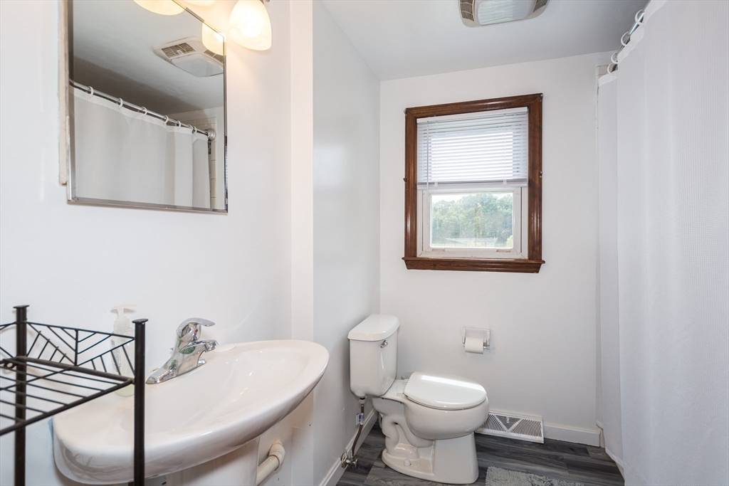 266 Mason Road Northbridge, MA 01588 - Photo 11 of 25 a bathroom with a toilet a sink and mirror