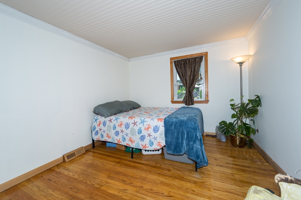 266 Mason Road Northbridge, MA 01588 - Photo 15 of 25 a bedroom with a bed windows and wooden floor