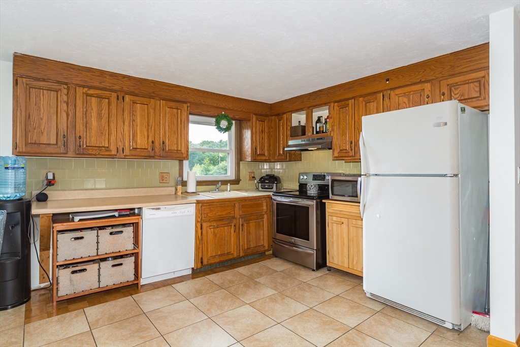 266 Mason Road Northbridge, MA 01588 - Photo 7 of 25 a kitchen with granite countertop a refrigerator stove top oven and sink