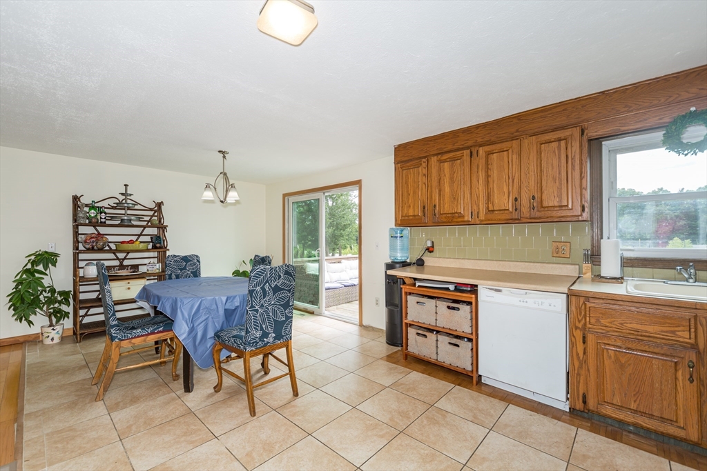 266 Mason Road Northbridge, MA 01588 - Photo 8 of 25 a kitchen with granite countertop wooden cabinets and dining table chairs
