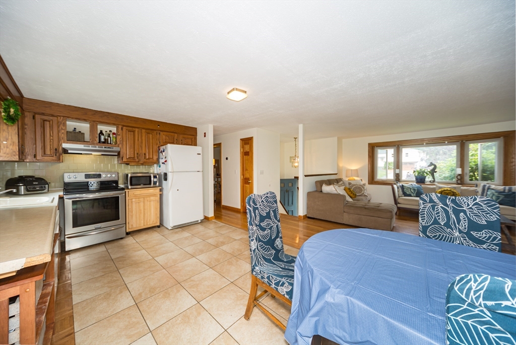 266 Mason Road Northbridge, MA 01588 - Photo 10 of 25 a living room with kitchen island furniture and a kitchen view