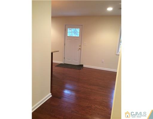 21 Stony Road Edison, NJ 08817 - Photo 11 of 23 a view of an empty room with wooden floor and a window