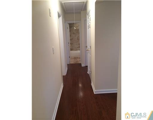 21 Stony Road Edison, NJ 08817 - Photo 12 of 23 a view of a hallway with wooden floor