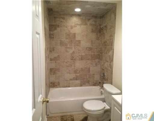 21 Stony Road Edison, NJ 08817 - Photo 13 of 23 a bathroom with a toilet and a bathtub