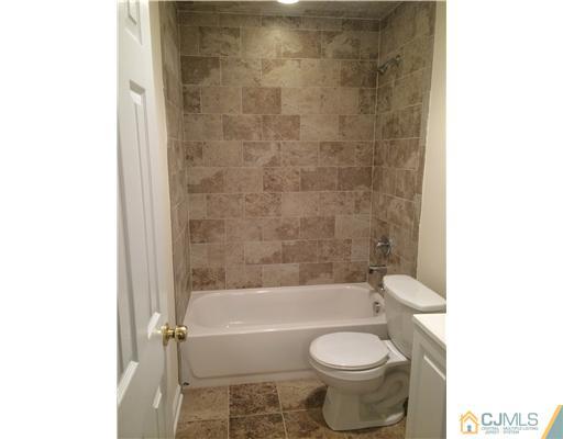 21 Stony Road Edison, NJ 08817 - Photo 14 of 23 a bathroom with a toilet and a bathtub