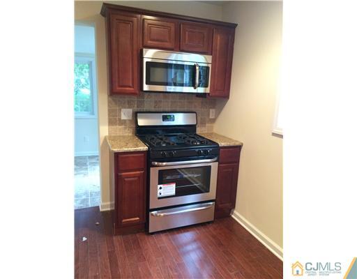 21 Stony Road Edison, NJ 08817 - Photo 6 of 23 a kitchen with a stove and a microwave