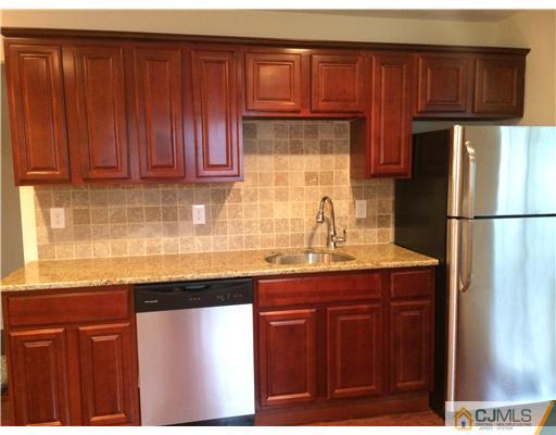 21 Stony Road Edison, NJ 08817 - Photo 8 of 23 a kitchen with stainless steel appliances granite countertop wooden cabinets a sink and dishwasher