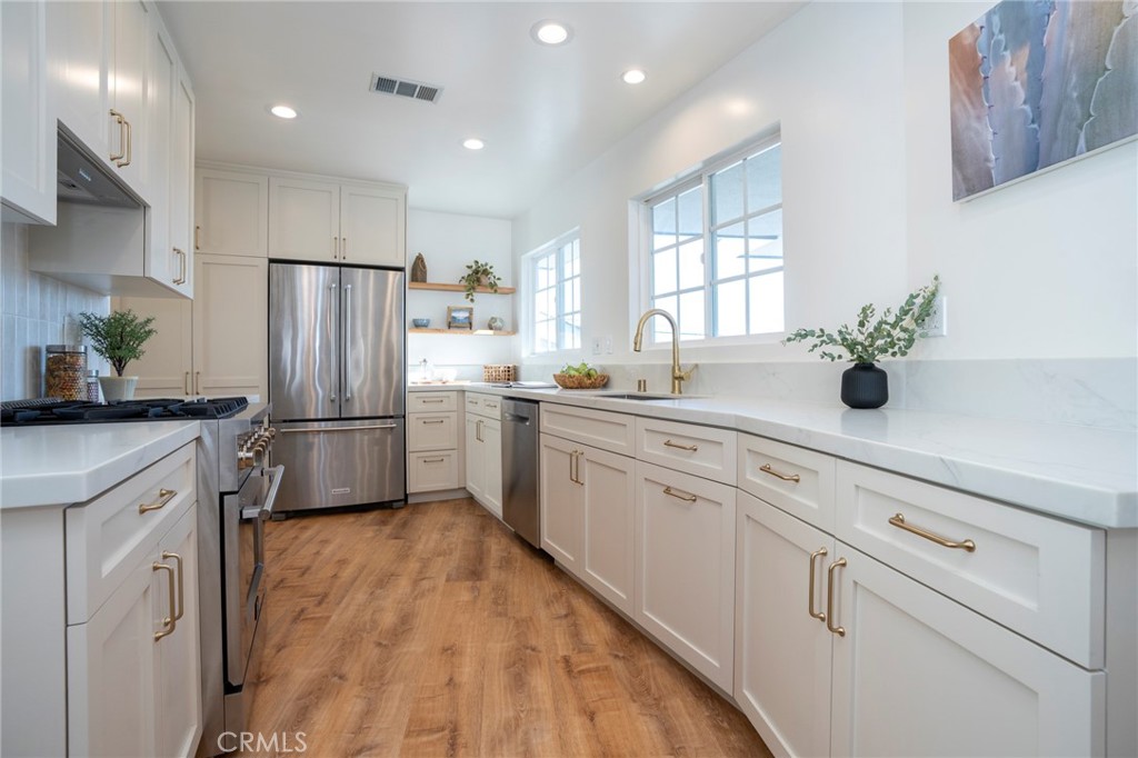 1718 West 27th Street San Pedro, CA 90732 - Photo 11 of 42 a kitchen with white cabinets and white stainless steel appliances
