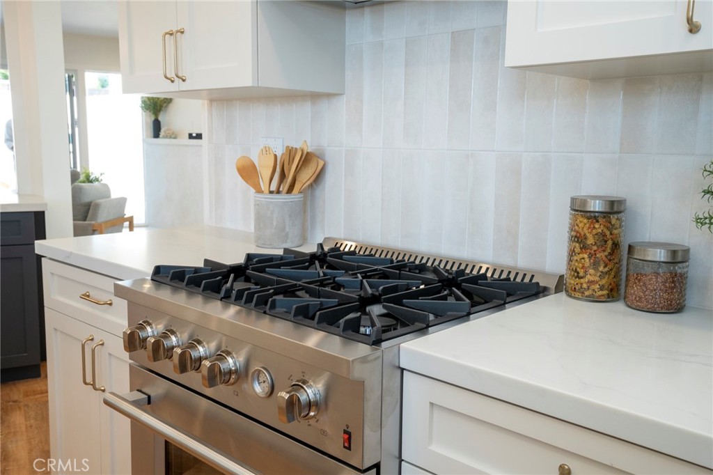 1718 West 27th Street San Pedro, CA 90732 - Photo 14 of 42 a close view of a stove a microwave and cabinets in the kitchen