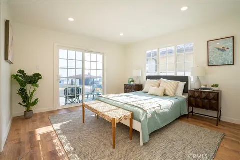 a bedroom with a bed and a potted plant