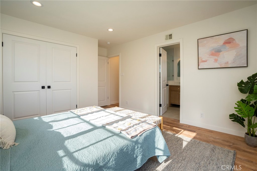 1718 West 27th Street San Pedro, CA 90732 - Photo 26 of 42 a bedroom with a bed and a potted plant